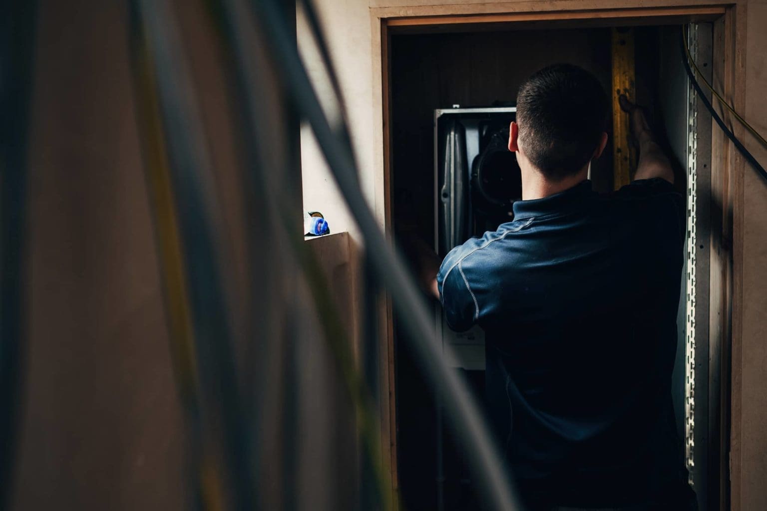 Heatmyhohm providing Landlord Services repairing a refrigerator in a room.