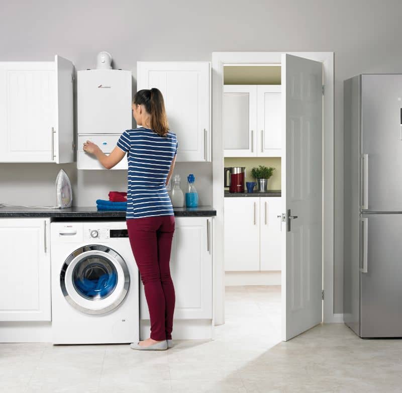A woman checking the installed Worcester Boiler, considering the 7.9% low interest option.